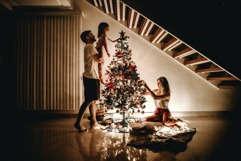 family next to the christmas tree