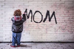 child writing mom on the wall graffiti